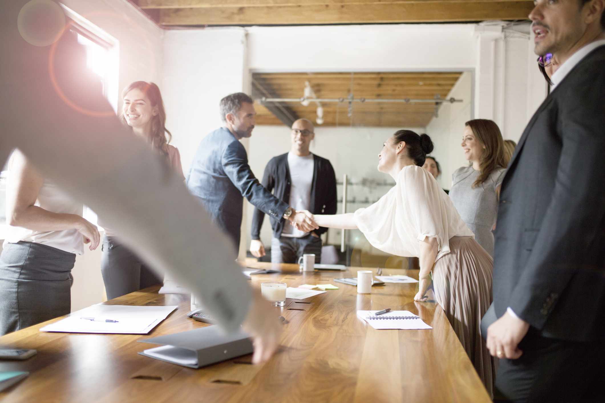 Businesspeople shaking hands during meeting in conference room