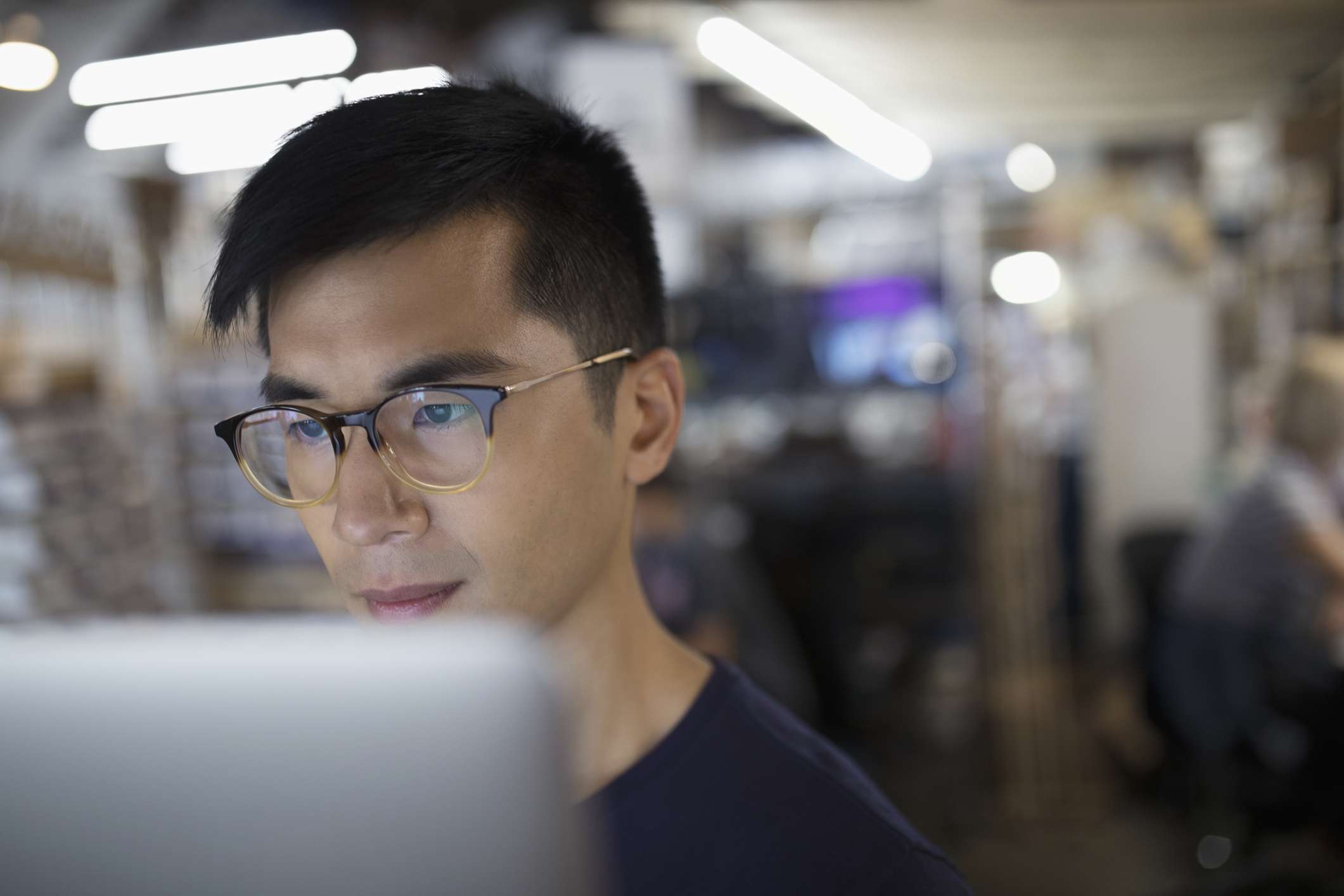 Focused engineer working at laptop