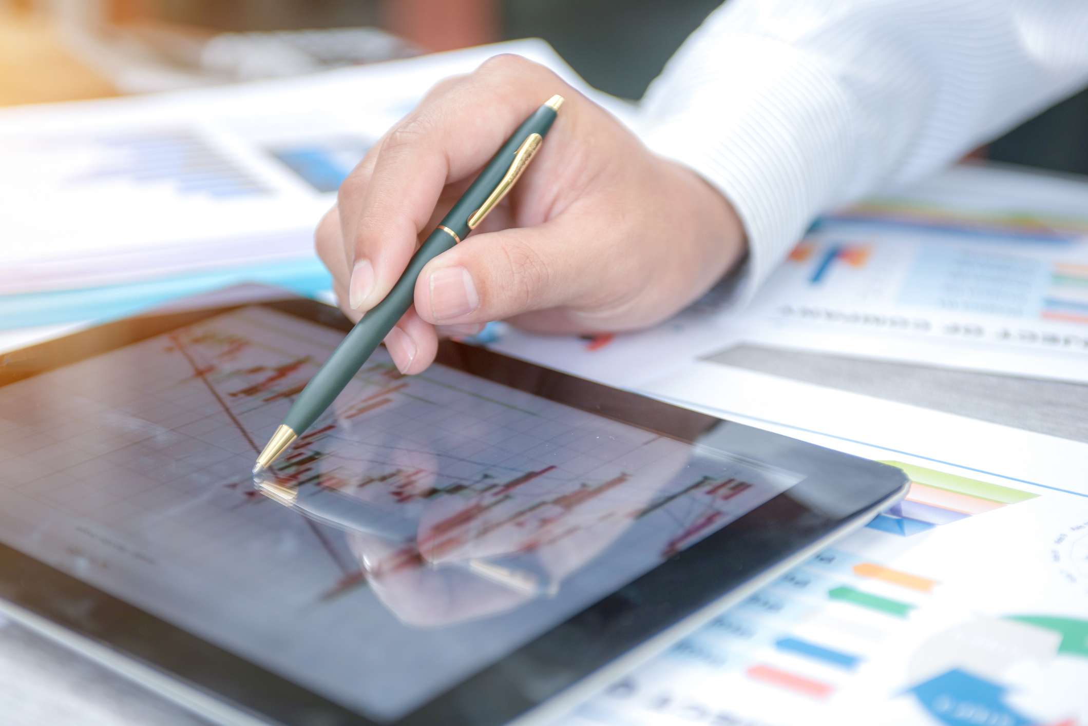 Businessman analyzing report on the tablet.