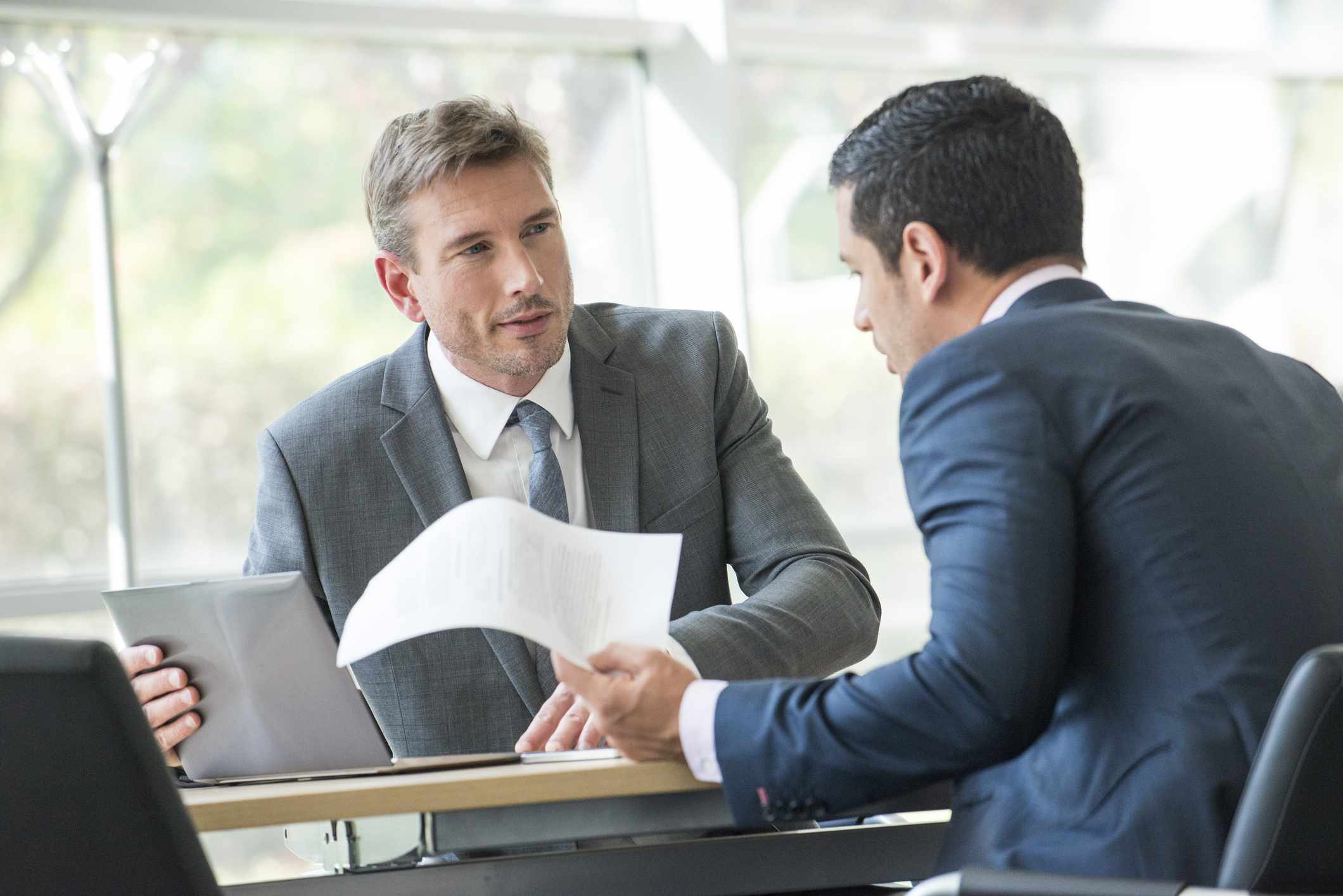 Businessmen negotiating in meeting.