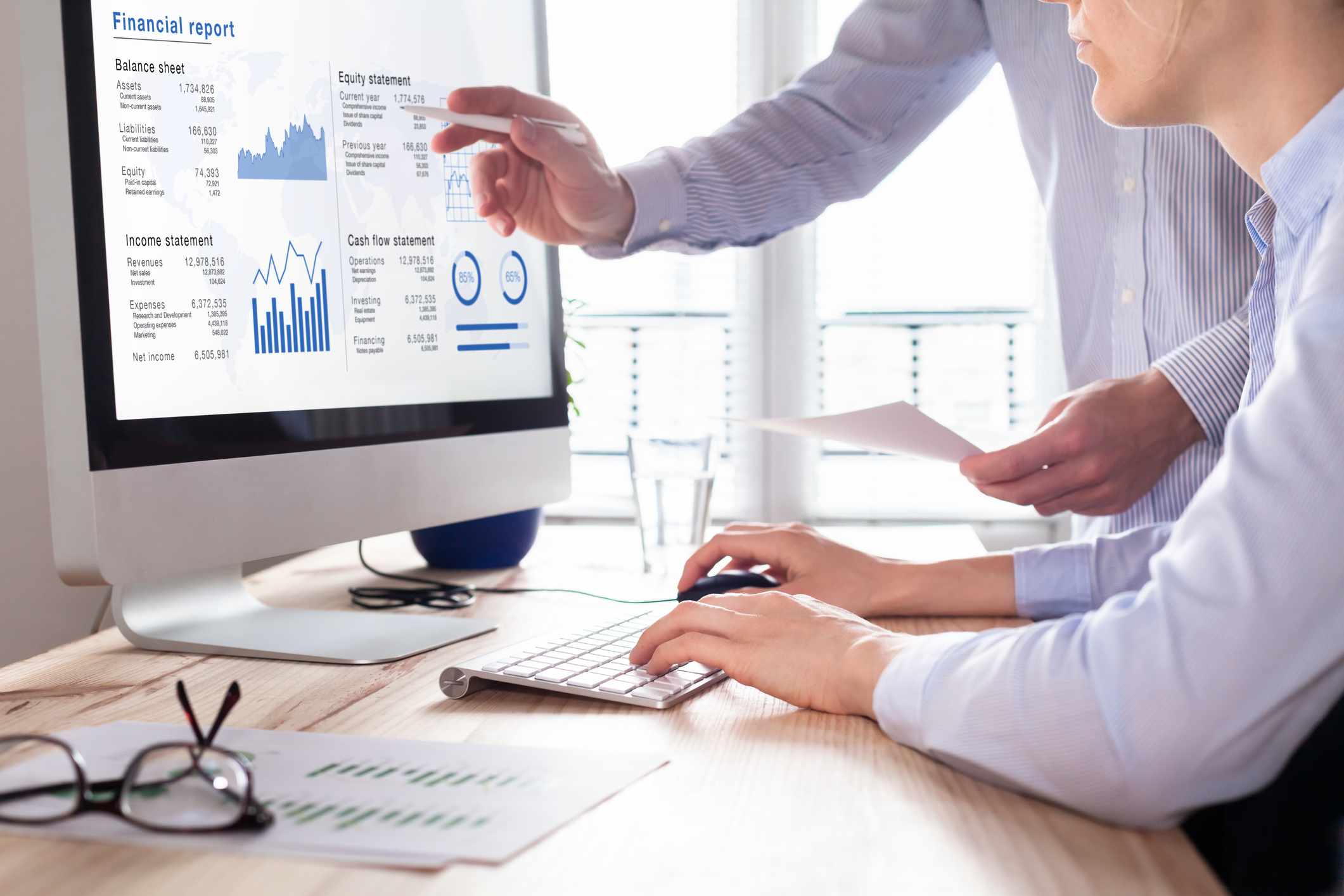 businessmen working on computer screen with business charts.