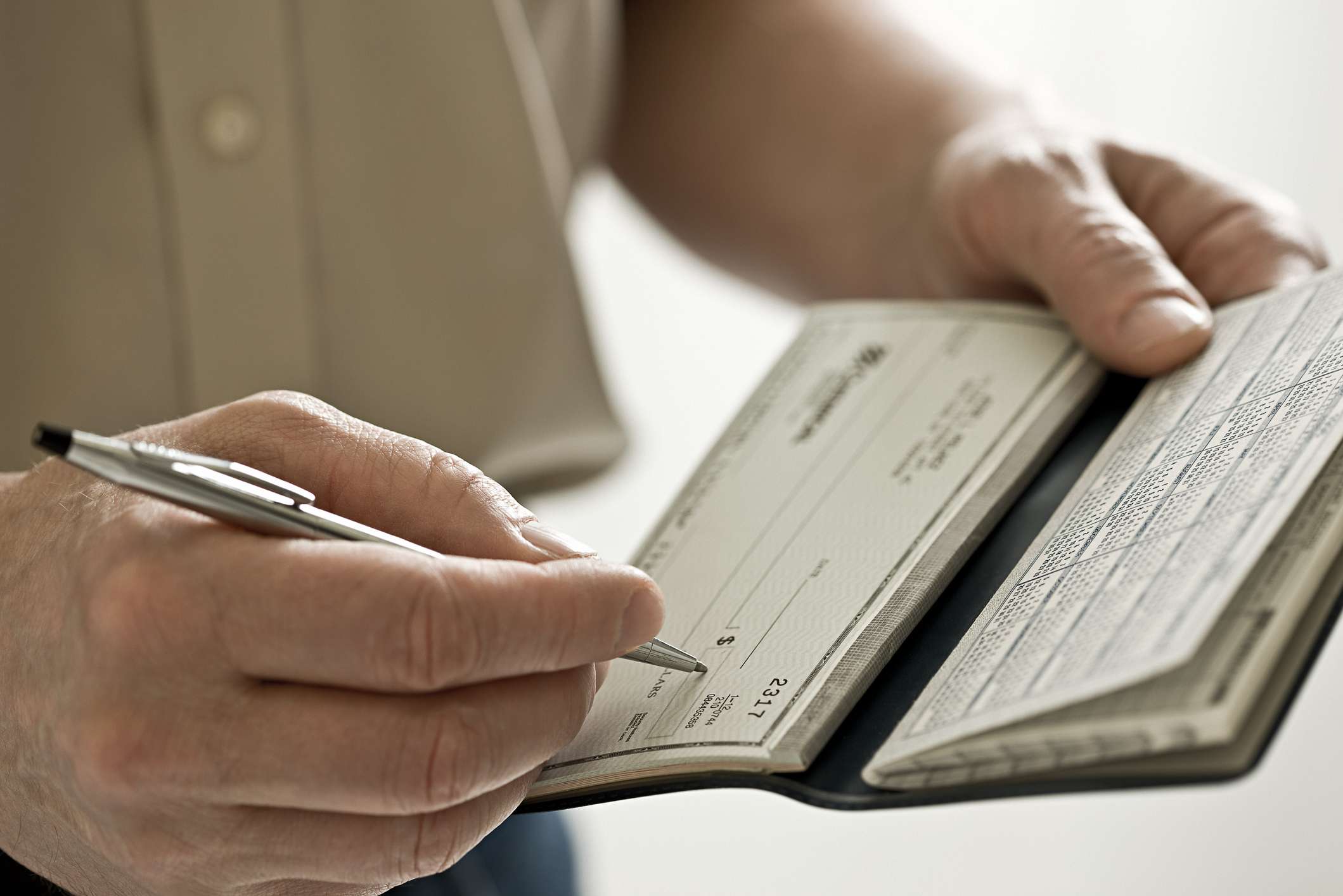 A man holding a cheque book.