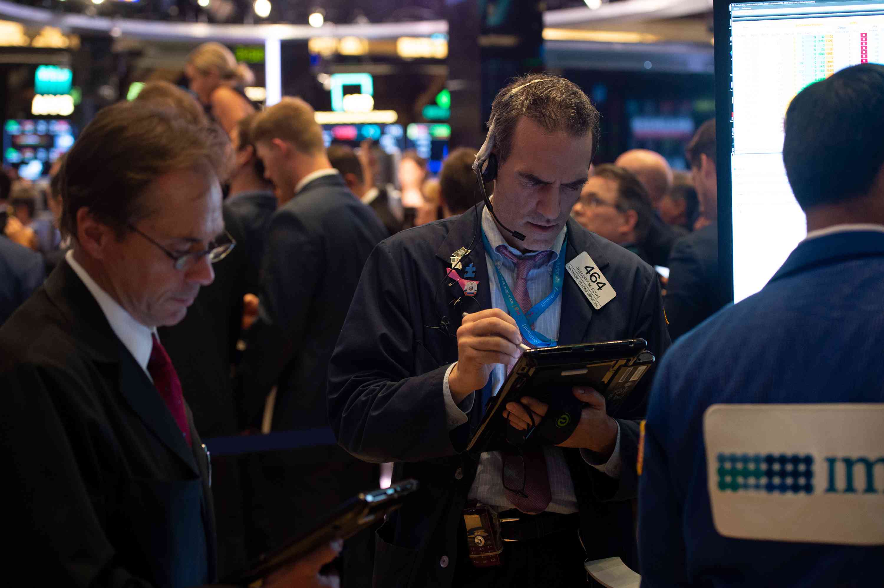 Traders work on the floor at the closing bell of the Dow Industrial Average at the New York Stock Exchange