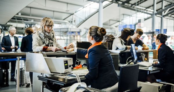 People checking in for flights at an airport