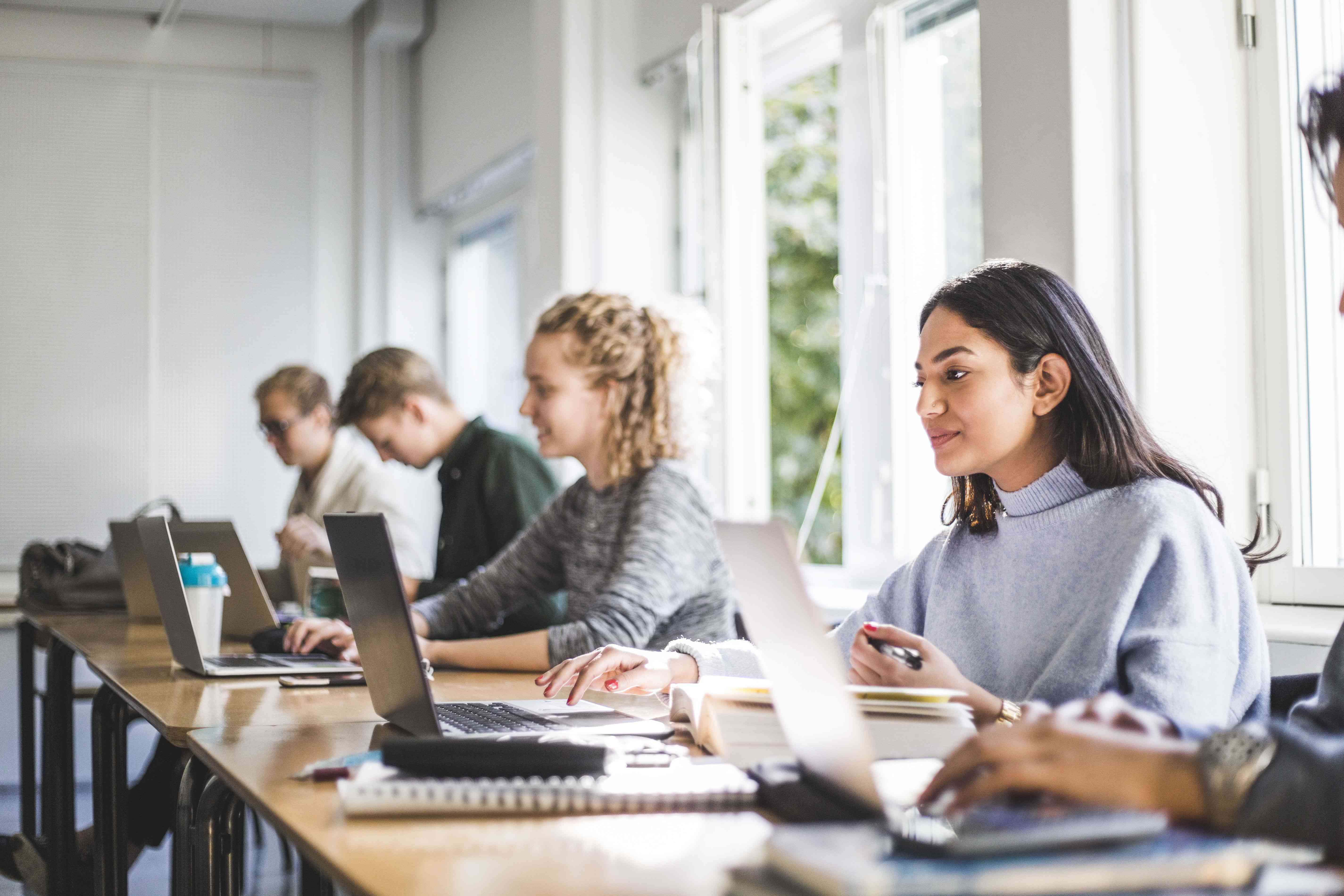 Students working on laptops in a classroom