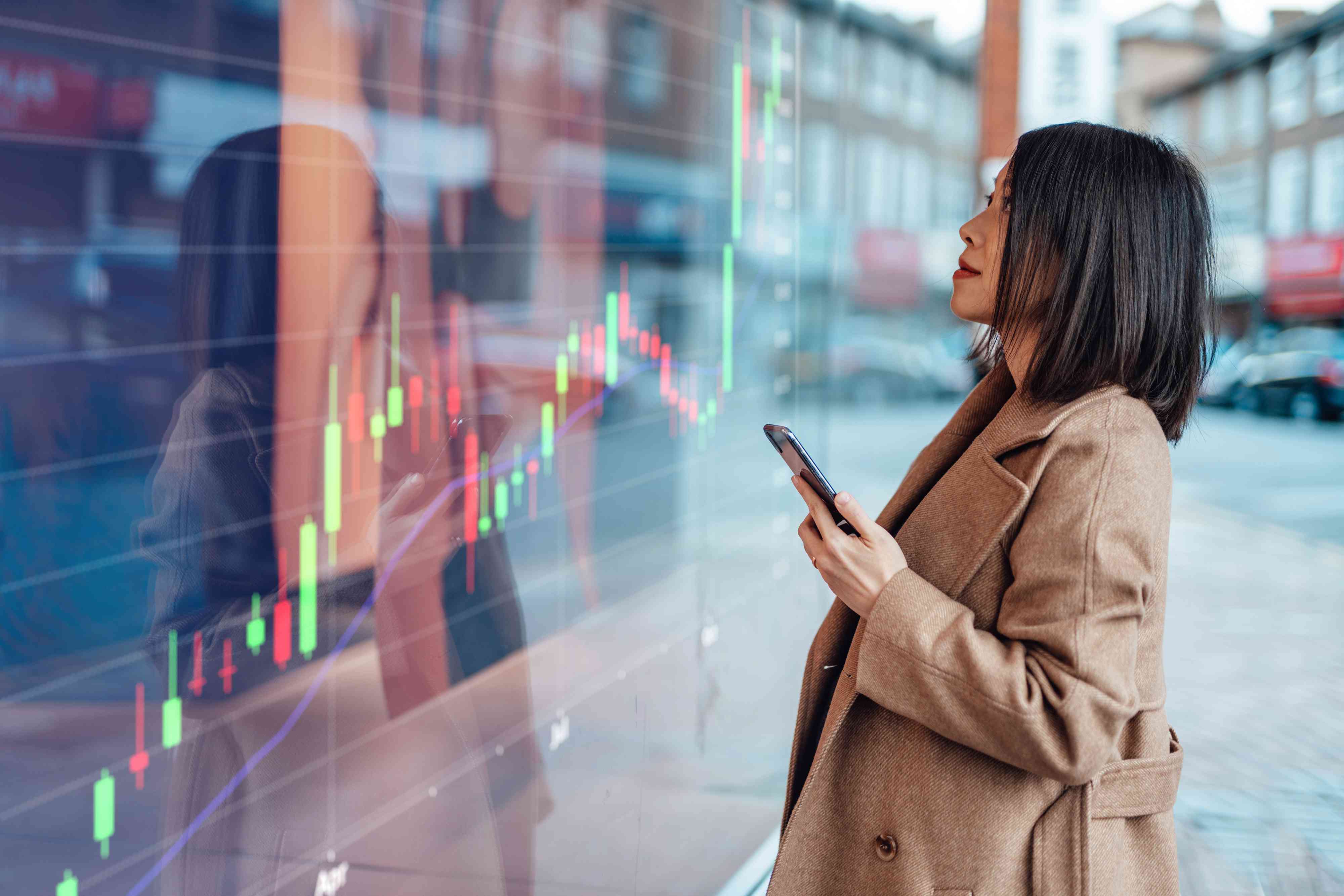 businesswoman looking at stock exchange market trading board for Ape Coin