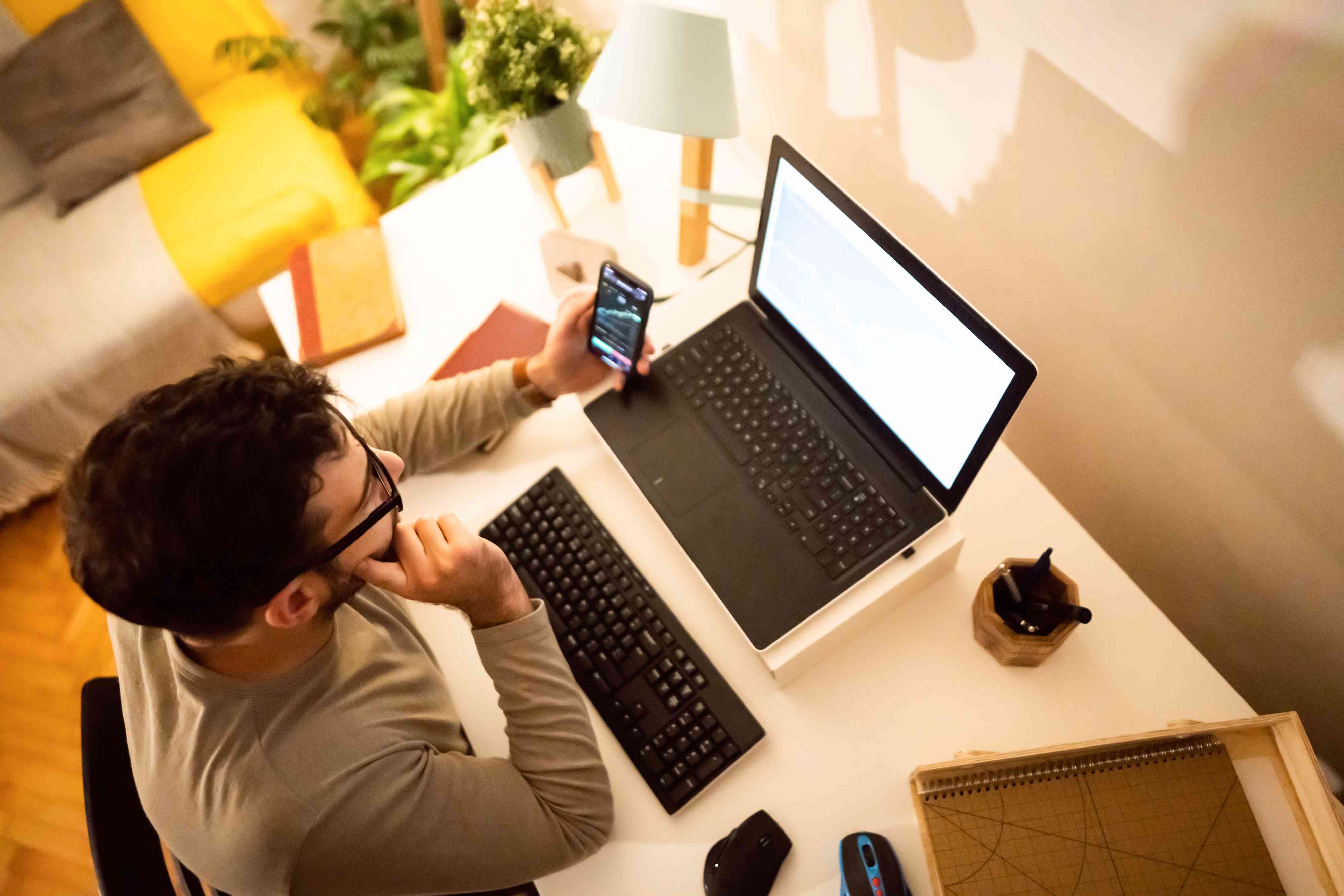 man analyzing NFTs graph on laptop screen